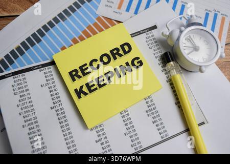 Concept of record keeping write on sticky notes isolated on Wooden Table. Stock Photo