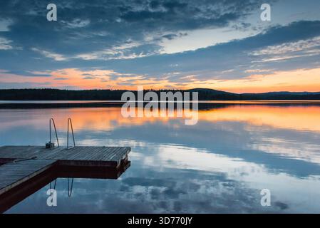 Small jetty by the evening lake Stock Photo