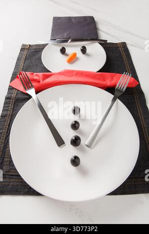 Christmas or New Year's table setting idea: snowman composition. Vertical Stock Photo