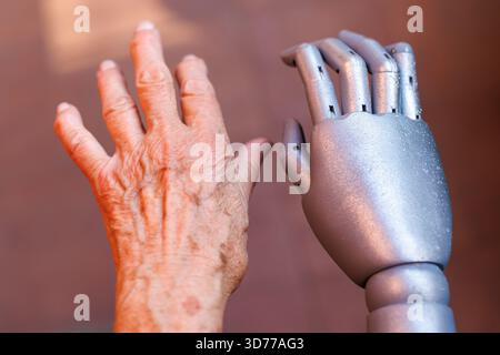 Human hand and robotic hand side by side Stock Photo