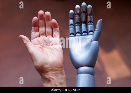 Human hand and robotic hand side by side Stock Photo