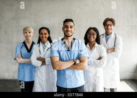 International team of doctors posing together while having morning breefing Stock Photo