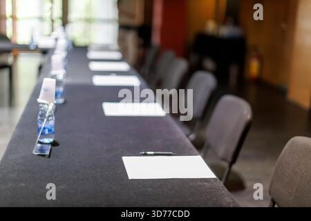 Empty conference table with papers and pens ready for a meeting Stock Photo