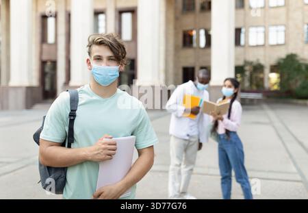 Group of Students Studying Together Outside During a Sunny Day at a University Campus Stock Photo