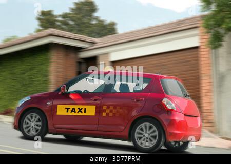 Taxi car with top sign and logo driving on road. Motion blur effect Stock Photo