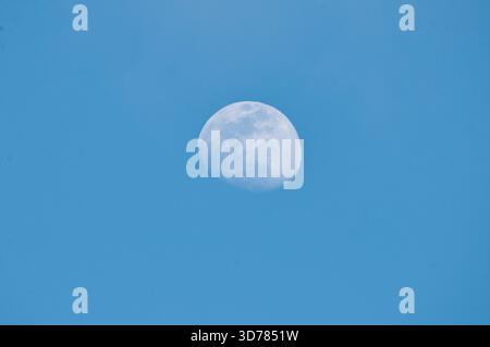 Bright moon against a blue sky. Stock Photo