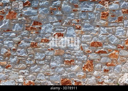 Gray and red stone wall in the mediterranean style texture Stock Photo