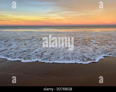 Wave washing onshore at sunrise on the beach at Chacala, Nayarit, Mexico. Stock Photo