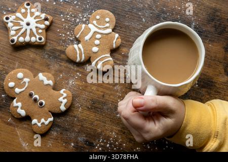 Warm Holiday Coffee and Gingerbread Cookies on Rustic Wooden Table Stock Photo
