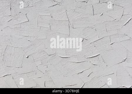 Textured white plaster wall with patterns, background for design or decoration purposes Stock Photo