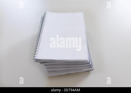 stack of blank spiral notebooks ready for writing at a clean workspace Stock Photo