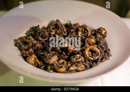 Delicious seafood dish featuring mollusks and black beans served in a local restaurant at night Stock Photo
