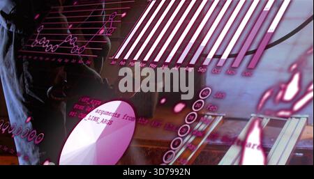 Standing male in dark blazer studying charts at office, with tablet, pie chart, code, copy space Stock Photo