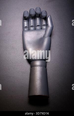 robotic hand displayed on black surface Stock Photo