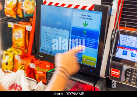 Close up view of CVS self checkout touchscreen where woman selects payment option on terminal. Miami. USA. Stock Photo