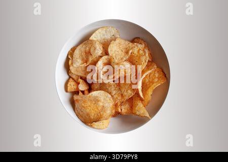 Potato chips in a white bowl Stock Photo
