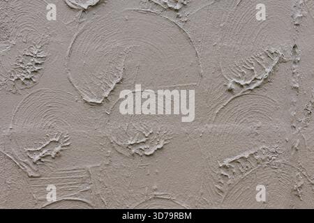 Close view of a textured wall featuring circular and wavy patterns, creating a calm atmosphere in a room. Stock Photo