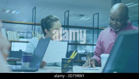 Reviewing printed document, woman and senior man in button-up shirt pointing at notebook in office Stock Photo