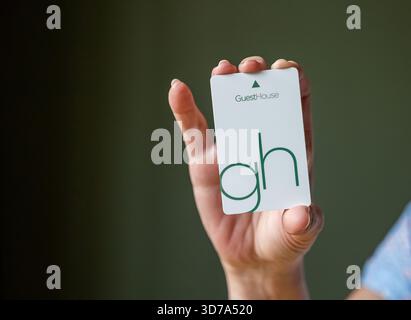 BEMIDJI, MN - 20 JUL 2020: Womans hand holding room security keycard for GuestHouse Hotels brand in close-up view. Stock Photo