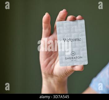BEMIDJI, MN - 20 JUL 2020: Womans hand holding room security keycard for Sheraton Hotels in close-up view. Stock Photo