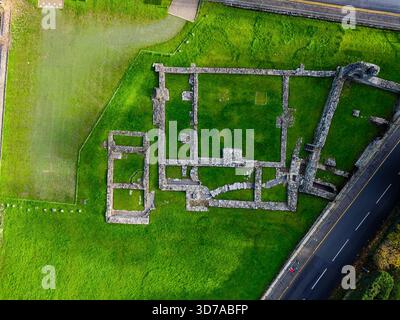 Top-down perspective of historic Tintern Abbey's stone foundations on vibrant green grass Stock Photo