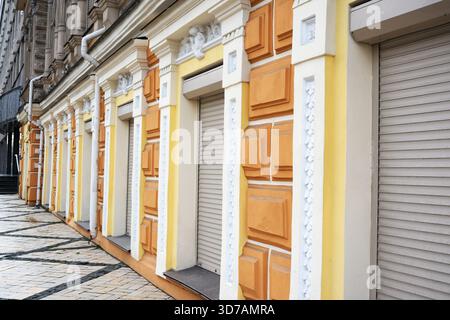 Colorful and detailed building facades stand closed along a peaceful urban street. Stock Photo