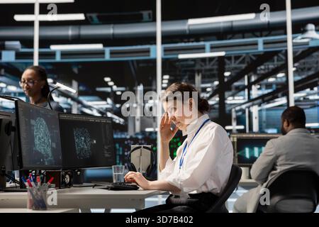 Overworked data center IT expert feeling headache while using artificial intelligence neural networks. Exhausted server farm developer having migraine from working too hard, using AI on computer Stock Photo