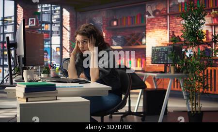Devastated sad woman losing financial value on stock trading platform, crying and being stressed following market crash. Worried overwhelmed investor deals with monetary losses. Camera A. Stock Photo