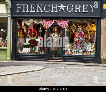 Decorated storefront of a shop named French Grey with festive Christmas ornaments and holiday window display Cirencester Gloucestershire UK Stock Photo