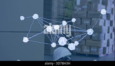 Displaying AR overlay above boxes on pallets in warehouse, worker wearing white hard hat Stock Photo