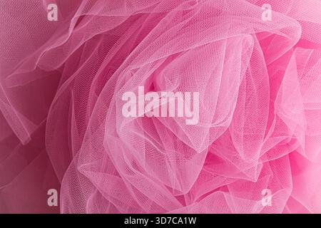 swirling swirls of beautiful transparent pink fabric. Chic pink spiral twisted veil. Soft waves of transparent fabric for veil. layout for design Stock Photo