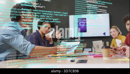 Discussing six-person team in smart casual reviewing app in office with wall monitor and laptop Stock Photo