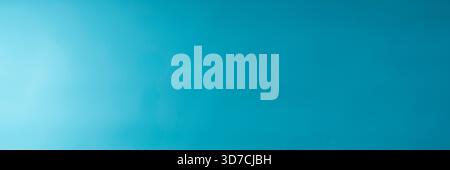 Panoramic view of the blue wall illuminated from the side. Turquoise blue soft wall surface Stock Photo