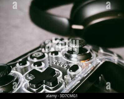 transparent game controller and wireless headphones gaming setup technology Stock Photo