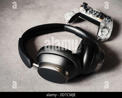 transparent game controller and wireless headphones gaming setup technology Stock Photo