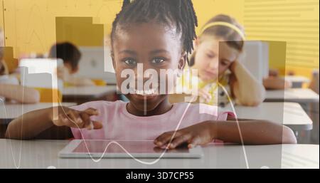 Smiling African American student using tablet at elementary classroom, wearing pink shirt, graphs Stock Photo
