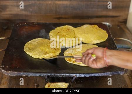 Cooking fresh tortillas on a hot griddle, a traditional Mexican food preparation Stock Photo