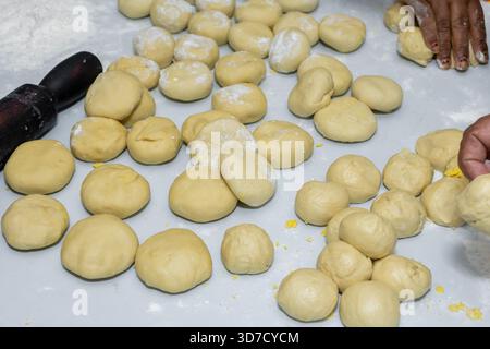 Preparing dough balls for cooking, a close-up shot of the process Stock Photo