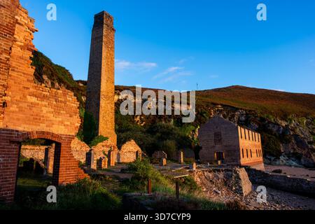 Brick chimney tower at Porth Wen in warm morning light Stock Photo