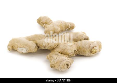 Organic ginger captured under clean white lighting, emphasizing its irregular natural shapes and detailed patterns. Stock Photo
