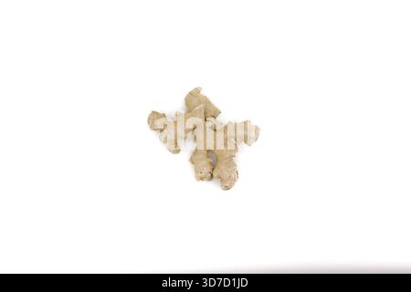 Raw ginger root displayed under bright white lighting to emphasize its natural structures. Stock Photo
