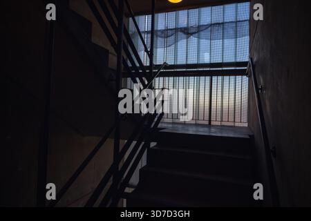 Dim staircase of a residential tower block Petticoat Tower, part of Middlesex Street housing estate in the City of London, UK Stock Photo