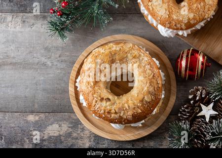 Close-up of a traditional Spanish Roscón de Reyes filled with whipped cream, decorated with sliced almonds and sugar on top Stock Photo