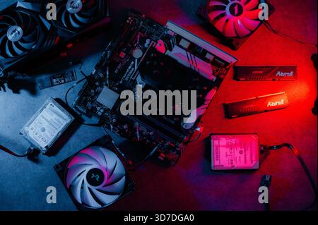 Graphics card and other computer hardware on grey textured table, flat lay. Space for text. Stock Photo