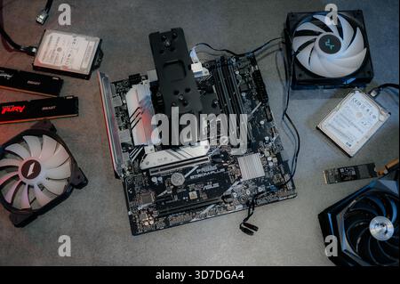 Graphics card and other computer hardware on grey textured table, flat lay. Space for text. Stock Photo