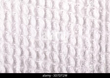 Close-up of soft white waffle fabric showing textured knit pattern, ideal for backgrounds, textiles, or design mockups. Stock Photo