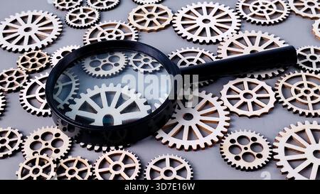 Magnifying Glass Focusing on Gears: Detailed Mechanical Analysis, Inspection, and Complex System Research Stock Photo