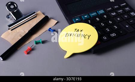 Tax Efficiency Note with Calculator and Office Supplies: Finance Planning and Business Strategy Stock Photo