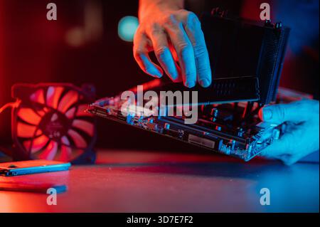 Man assembles a computer system unit at home Stock Photo
