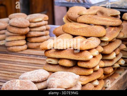 Freshly baked traditional flatbread (Khobz) on a cart for sale  in a street market of Morocco. Traditional Moroccan flatbread on street food stall. Stock Photo